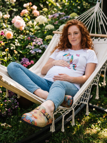 Calceo.co clogs with a whimsical pattern of winged unicorns and colorful owls, featuring adjustable straps and a comfortable sole.