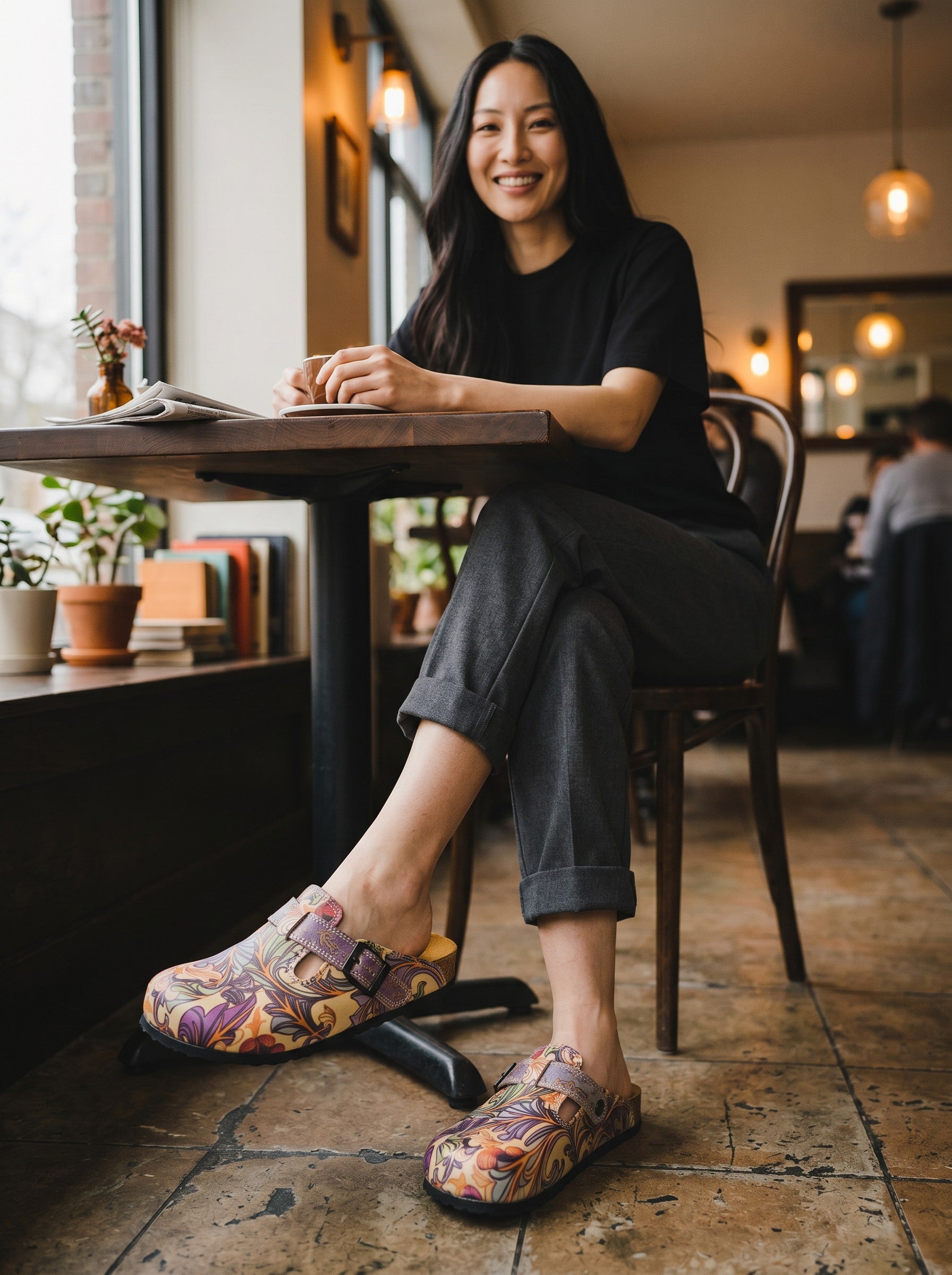 Calceo.co clogs with purple, pink, orange floral and green leaf pattern. Adjustable strap, cork sole, artificial leather and cotton canvas.
